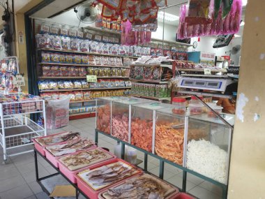 Perak, Malaysia. February 13,2020: Varieties of dried Asian seafood or snacks on displayed on shelves for sale at Pangkor Dried Seafood Supermarket.