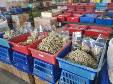 Perak, Malaysia. February 13,2020: Varieties of dried Asian seafood or snacks on displayed on shelves for sale at Pangkor Dried Seafood Supermarket.