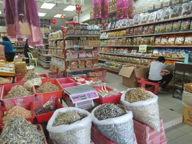 Perak, Malaysia. February 13,2020: Varieties of dried Asian seafood or snacks on displayed on shelves for sale at Pangkor Dried Seafood Supermarket.