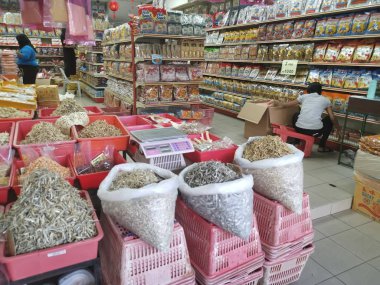 Perak, Malaysia. February 13,2020: Varieties of dried Asian seafood or snacks on displayed on shelves for sale at Pangkor Dried Seafood Supermarket.