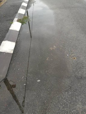puddle by the street after the rain.