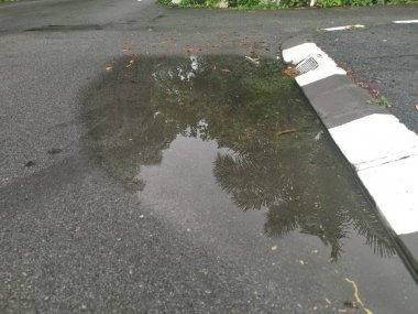 puddle by the street after the rain.