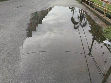 puddle by the street after the rain.