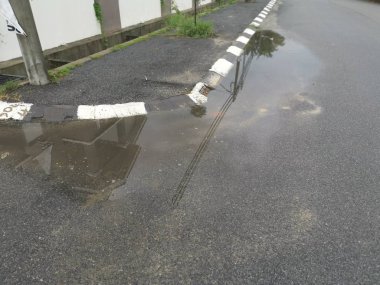 puddle by the street after the rain.