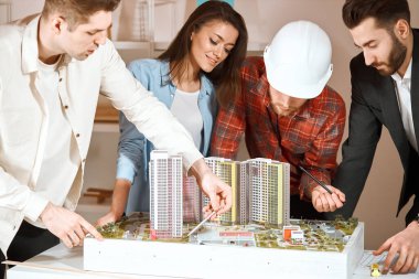 young engineers discussing apartment renovation idea at meeting,