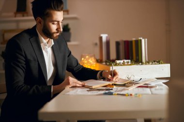 young man in stylish formal clothes develops the concepts for structures