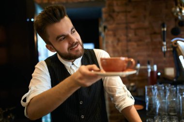 handsome stylish waiter advising wonderful tea