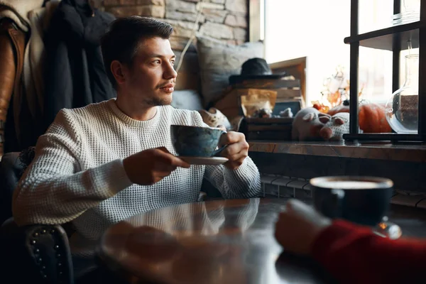 thoughtful man thinking about his love, girlfriend, while looking at the window