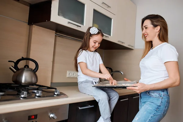 Little cheerful girl making surprise to her granny — Stock Photo, Image