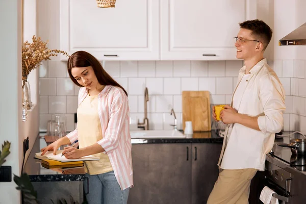 Mujer joven que estudia en la cocina —  Fotos de Stock