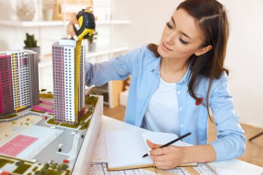 young talented architect performing construction drawings