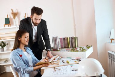 team leader making notes while sitting at the desk