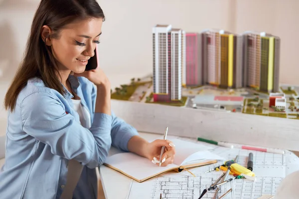 Young talented architect having pleasant conversation with clients — Stock Photo, Image