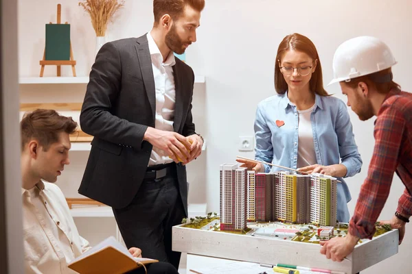 clever leader in glasses manages the process of construction