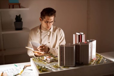 young serious designer finding some mistakes in the model