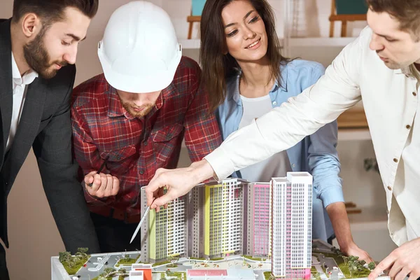 young architects discuss with female head engineer construction project.