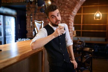 young waiter relaxing after working day