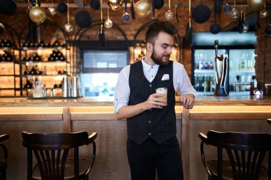 young man in fashion uniform inspired with good tasty latte