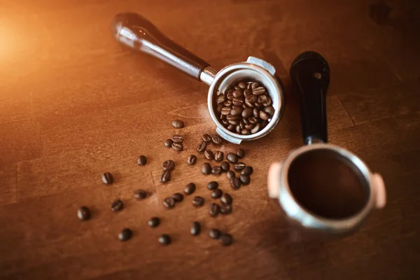 best coffee beans and portafilter on old white wooden table background.