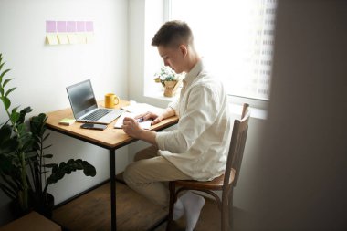 young man in casula clothes thinking about new business plan, planning his day
