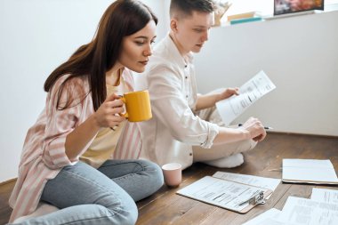 active serious student reads information in paper documents