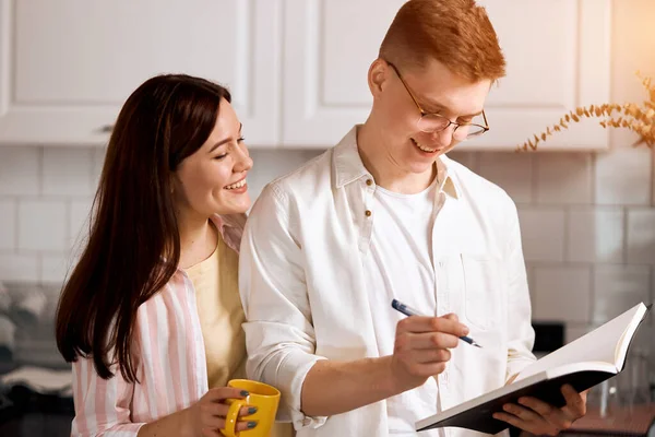 Young pleasant family counting callories — Stock Photo, Image