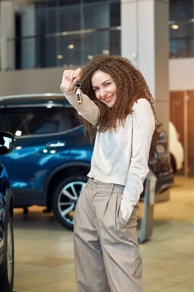 Excited funny girl has bought a new car — Stockfoto