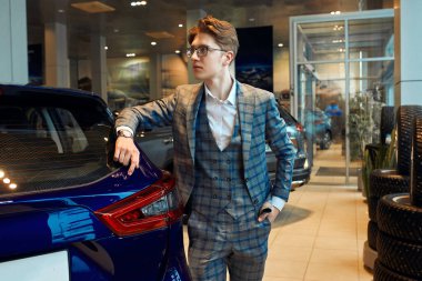 young good looking man advertising a new car