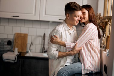 young couple having fun in the kitchen room