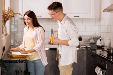 female writer sharing with her ideas with husband who is drinking coffee