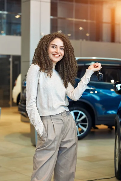 Attractive positive girl is happy as she has won the car — Stockfoto