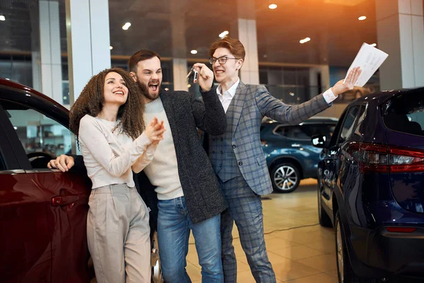 Funny crazy couple screaming , shouting , enjoying a new vehicle — Stockfoto