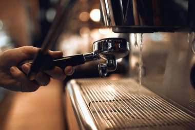 baarista working with coffee maker tools