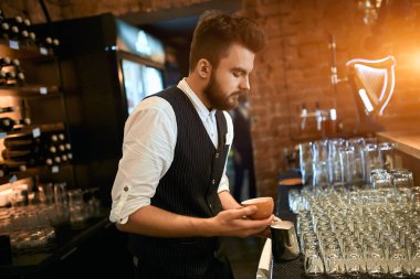 young man creating pleasant taste of coffee