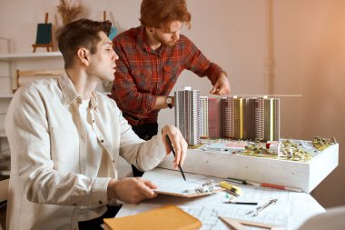young handsome men working on architectural project, planning construction