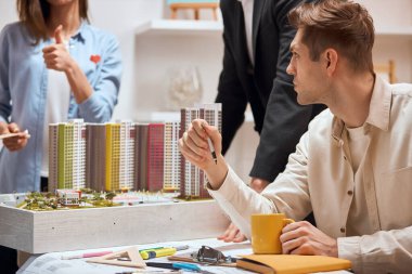 hardworking young people doing architecture small model dummy