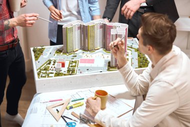 discussion about new neighbourhood, busy working atmosphere in the office
