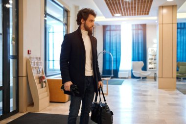 Businessman with briefcase looking aside