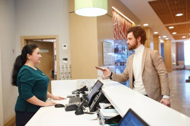 businessman checking in the hotel while having one day business trip