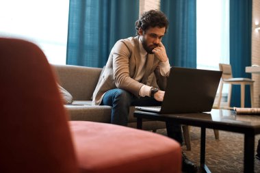 young thoughtful pensive man making up a plan