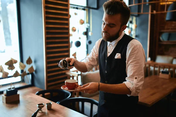 hardworking man in elegant suit concentrated on spilling the grounded coffee