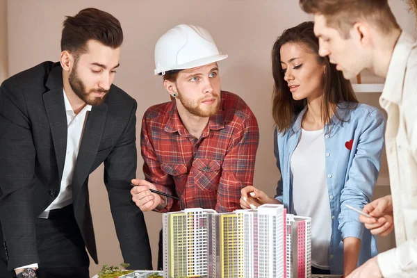 young talented male architect explaining his colleague the features of deal