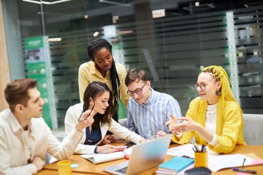 pleasant active young women and men making up plans how to earm much money