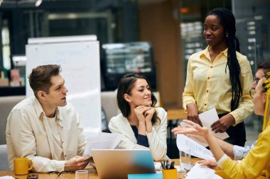 diverse people are talking in the office