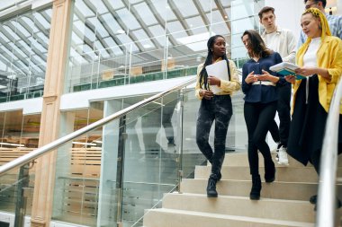 young ambitious talented office workers talking, discussing a new project