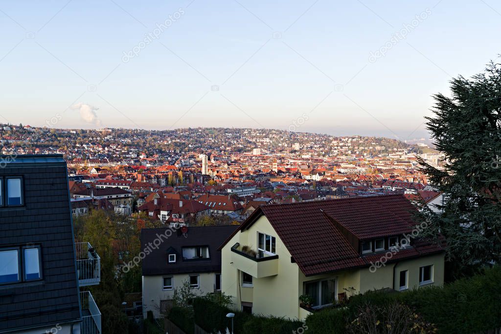 Germany, Skyline of city stuttgart in valley surrounded by hills covered by trees