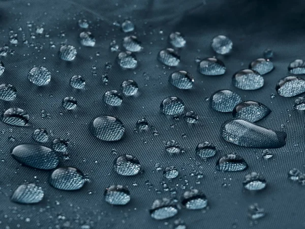 Gotas Agua Lluvia Sobre Tela Impermeable Fibra Azul Fondo Azul — Foto de Stock