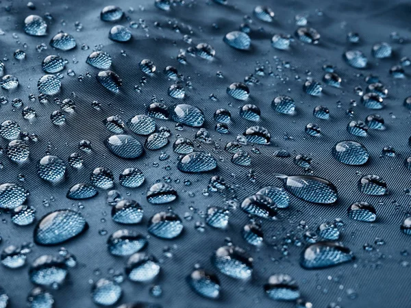 Gotas Agua Lluvia Sobre Tela Impermeable Fibra Azul Fondo Azul —  Fotos de Stock