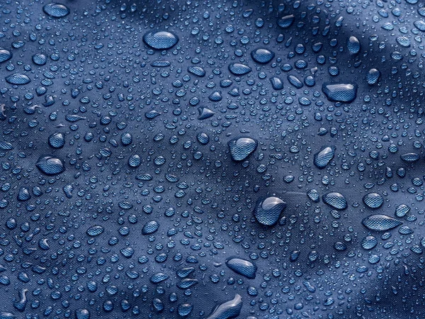 Gotas Agua Lluvia Sobre Tela Impermeable Fibra Azul Fondo Azul —  Fotos de Stock