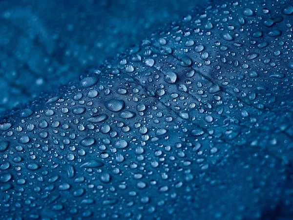 Gotas Água Chuva Tecido Impermeável Fibra Azul Fundo Azul — Fotografia de Stock